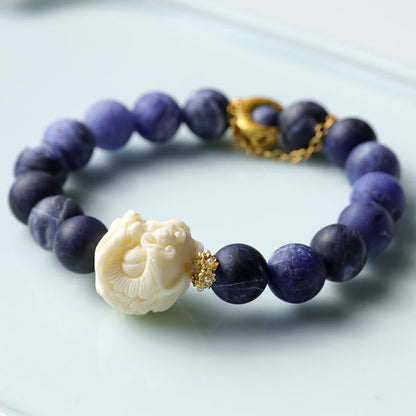 Pulsera de armonía con luna creciente y león danzante de marfil, sodalita y piedra mitológica