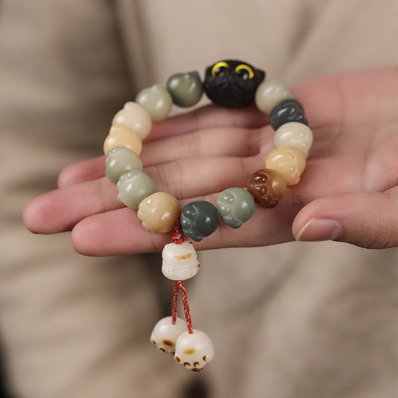 Pulsera de la suerte con forma de gato de la sabiduría y semillas de Bodhi naturales de Mythstone con forma de pata encantadora de madera de ébano 