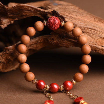 Pulsera de borlas de riqueza PiXiu con cinabrio de madera de melocotón natural tibetano Mythstone 