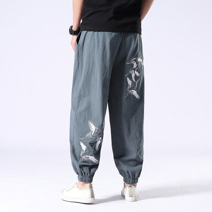 Pantalones harén con cordón y bolsillos para hombre con diseño bordado de grulla blanca de Mythstone 