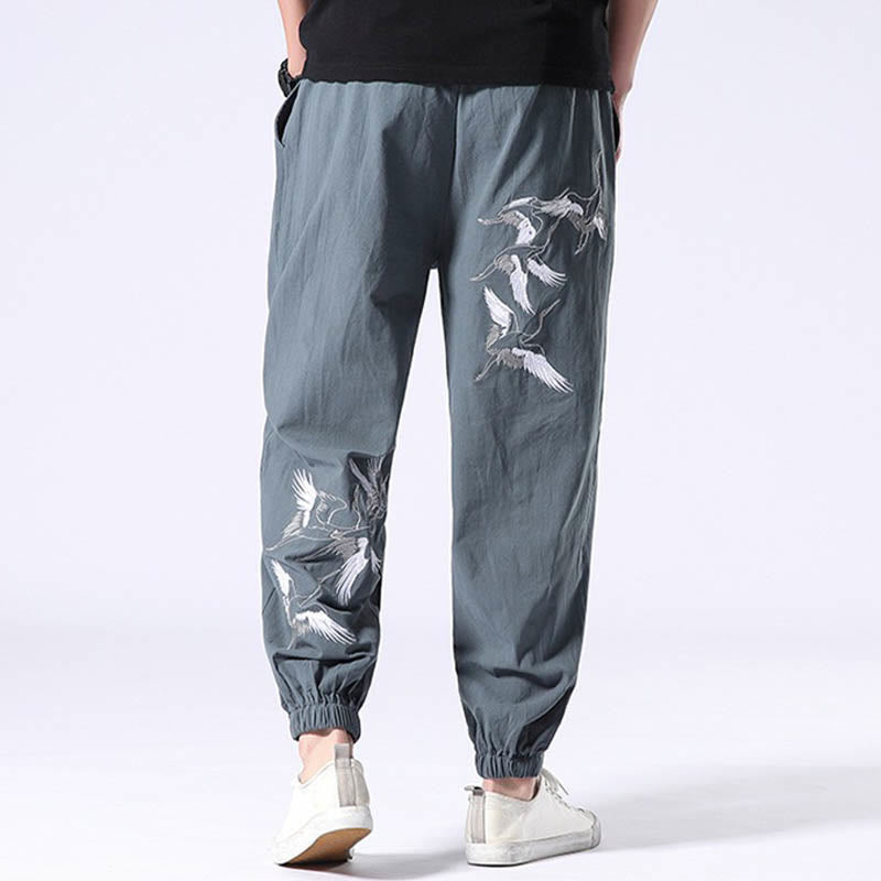 Pantalones harén con cordón y bolsillos para hombre con diseño bordado de grulla blanca de Mythstone 