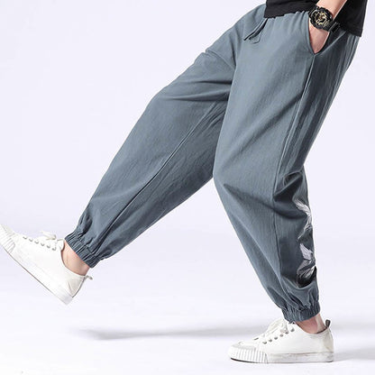 Pantalones harén con cordón y bolsillos para hombre con diseño bordado de grulla blanca de Mythstone 