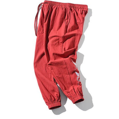 Pantalones harén con cordón y bolsillos para hombre con diseño bordado de grulla blanca de Mythstone 