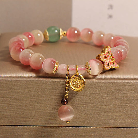 Pulsera de la paz con diseño de mariposa y ojo de gato en color rosa degradado de Mythstone