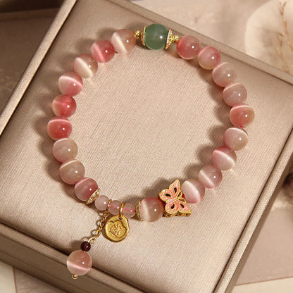 Pulsera de la paz con diseño de mariposa y ojo de gato en color rosa degradado de Mythstone