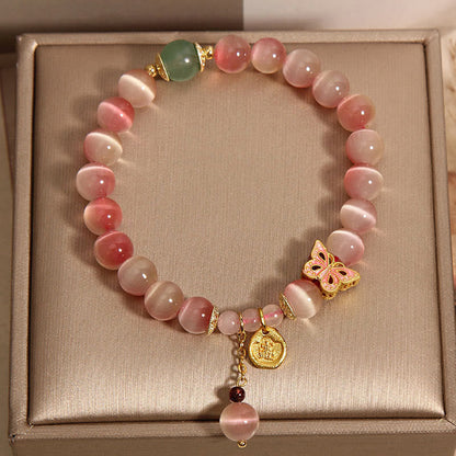 Pulsera de la paz con diseño de mariposa y ojo de gato en color rosa degradado de Mythstone