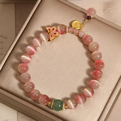 Pulsera de la paz con diseño de mariposa y ojo de gato en color rosa degradado de Mythstone