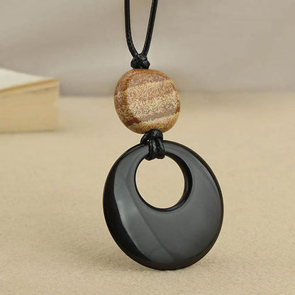 Colgante de collar con imagen de piedra de cobre con obsidiana negra y piedra mitológica de Liuli