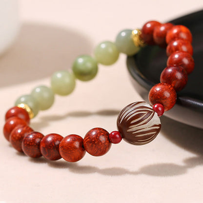 Pulsera de piedra de loto con semillas de bodhi, jade cian y palo de rosa natural que aporta calidez y calma