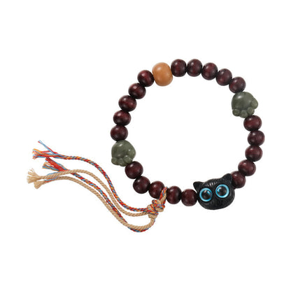 Pulsera de madera de ébano con borlas de la paz y pata de jade y gato encantador de Mythstone 