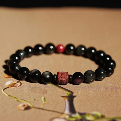 Pulsera curativa con personaje Om Mani Padme Hum Fu y obsidiana arcoíris con brillo dorado natural de Mythstone 