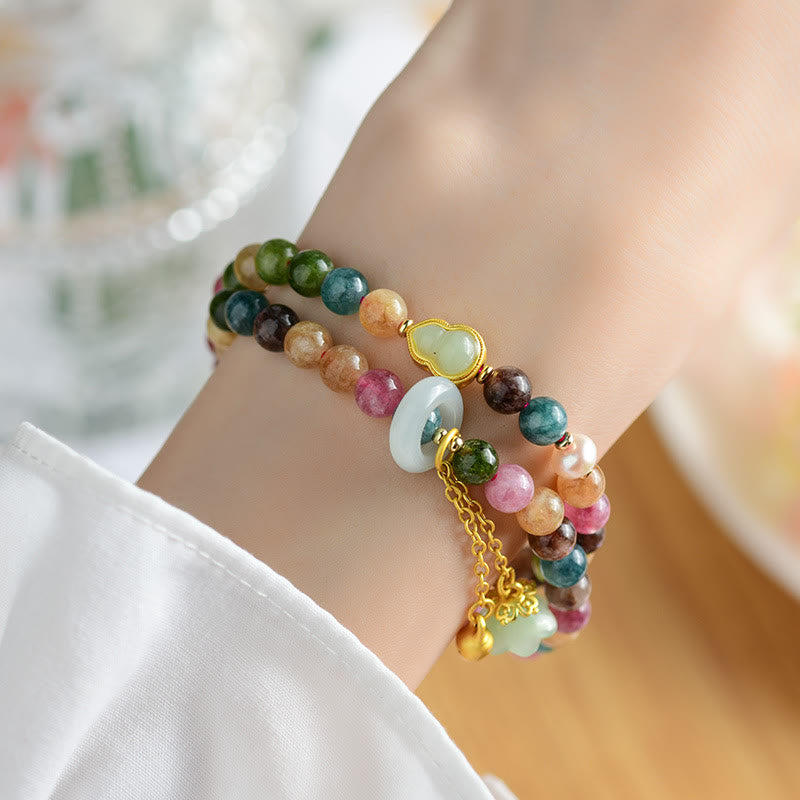 Pulsera con dijes de lirio de los valles y turmalina multicolor de Mythstone