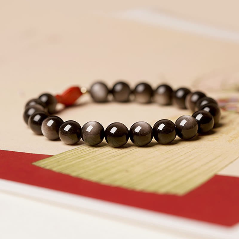 Pulsera protectora calmante con pez koi de obsidiana cinabrio con brillo plateado natural Mythstone 