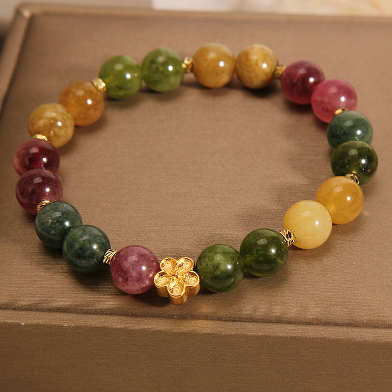 Pulsera positiva con flor dorada y turmalina natural de colores Mythstone