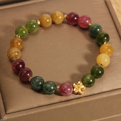 Pulsera positiva con flor dorada y turmalina natural de colores Mythstone