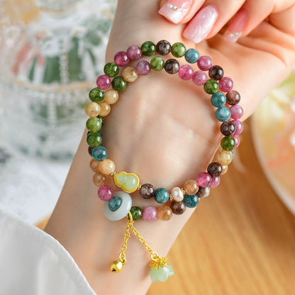 Pulsera con dijes de lirio de los valles y turmalina multicolor de Mythstone