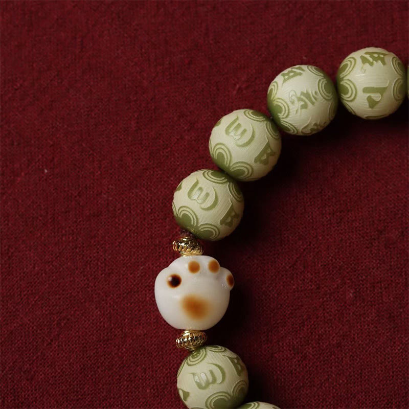 Pulsera de sabiduría grabada con pata de gato y semilla de Bodhi verde Mythstone Om Mani Padme Hum