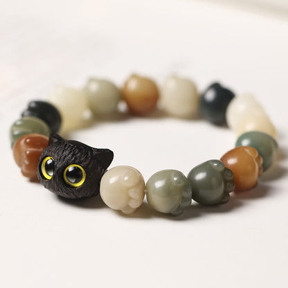 Pulsera de la suerte con forma de gato de la sabiduría y semillas de Bodhi naturales de Mythstone con forma de pata encantadora de madera de ébano 