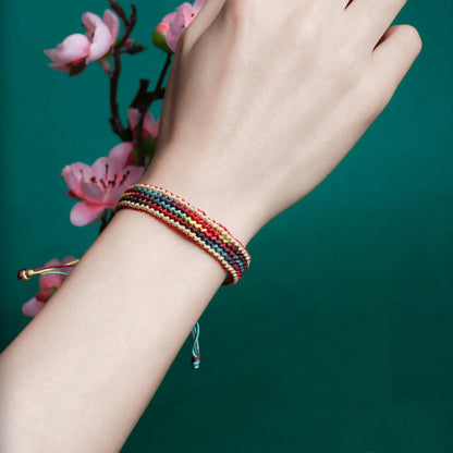 Pulsera trenzada de protección multicolor hecha a mano con piedra mítica del Tíbet