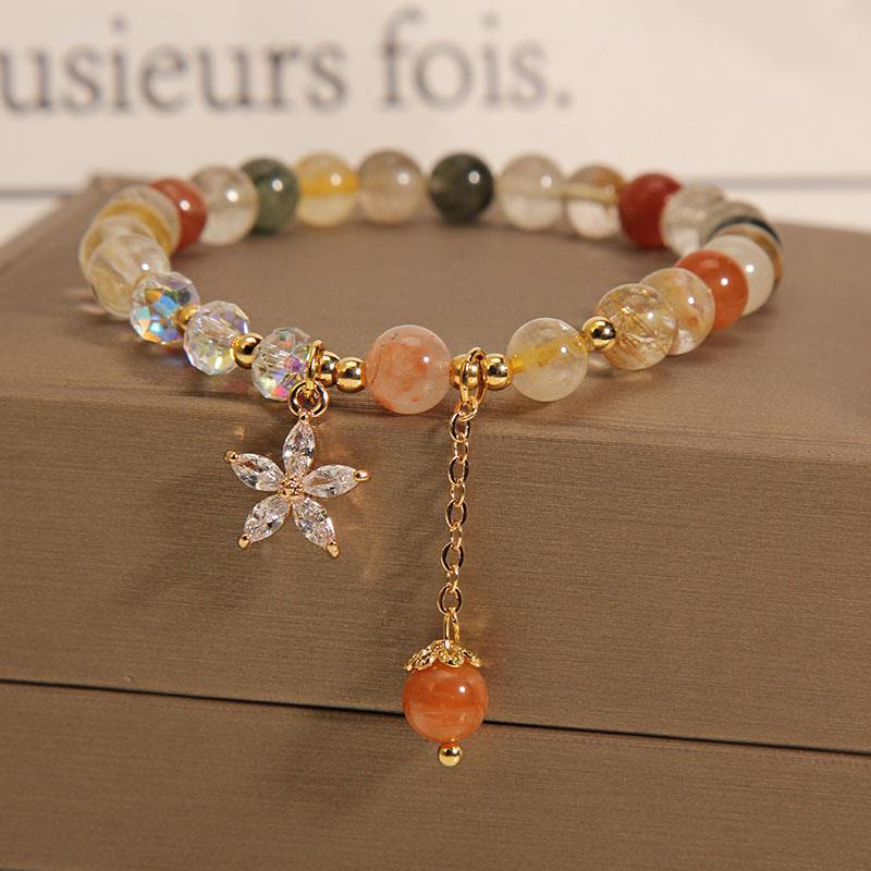 Pulsera de cuarzo rutilado multicolor con circonitas auspiciosas y flor de Mythstone