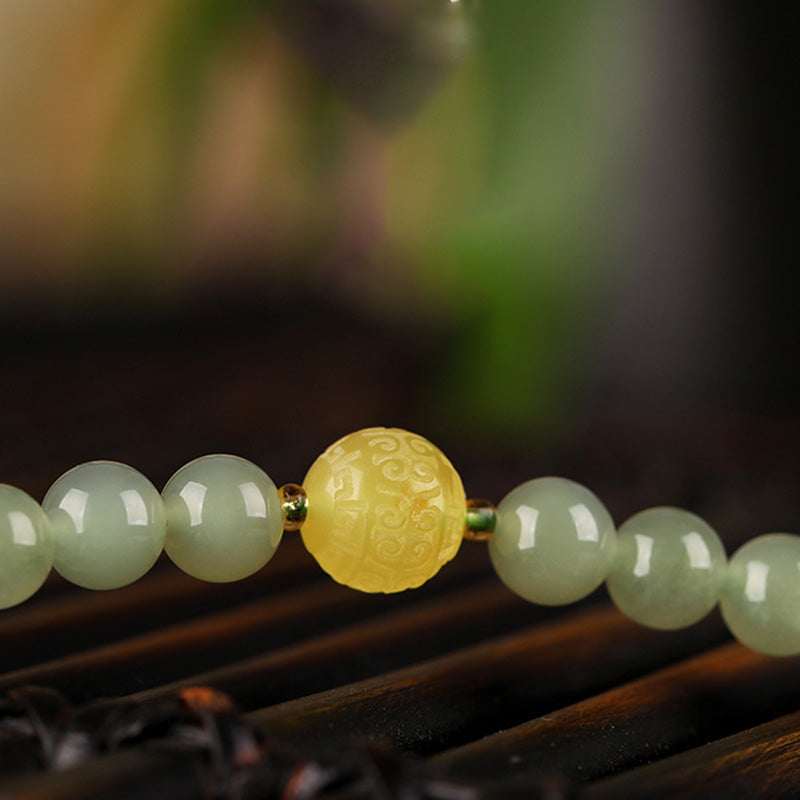 Pulsera de prosperidad con Buda sonriente, ámbar, ágata roja y jade de Mythstone