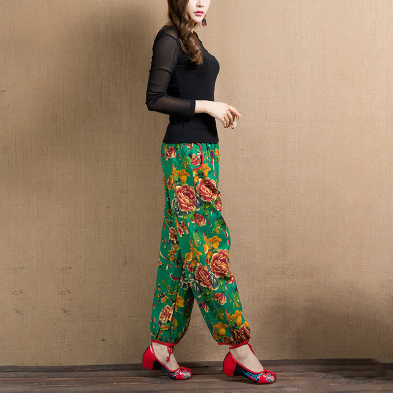 Pantalones harén con estampado de flores rojas y verdes de estilo étnico Mythstone y bolsillos 