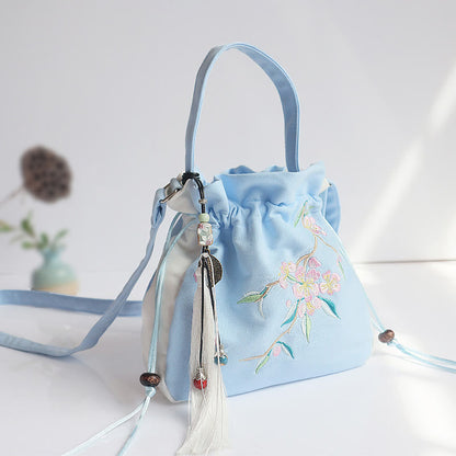 Bolso de mano de lona con flores bordadas a mano de Mythstone