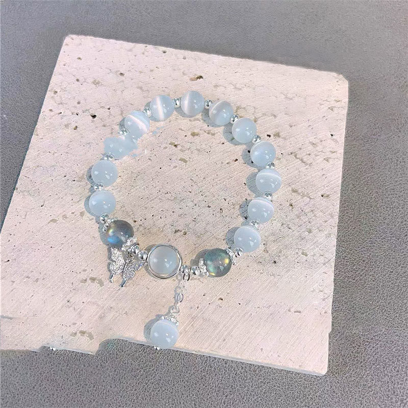 Pulsera de soporte con dije de estrella y mariposa con piedra lunar y ojo de gato de Mythstone