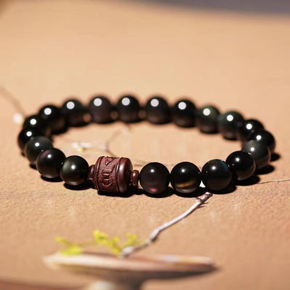 Pulsera curativa con personaje Om Mani Padme Hum Fu y obsidiana arcoíris con brillo dorado natural de Mythstone 