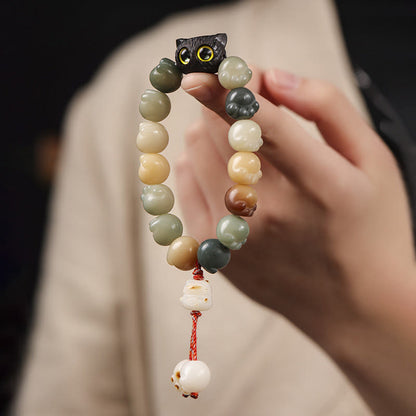 Pulsera de la suerte con forma de gato de la sabiduría y semillas de Bodhi naturales de Mythstone con forma de pata encantadora de madera de ébano 