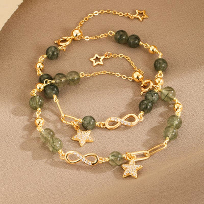 Pulsera de protección con estrellas del amor eterno y cuarzo rutilado verde en oro de 14 quilates de Mythstone con lazo Möbius 