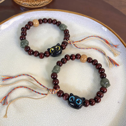 Pulsera de madera de ébano con borlas de la paz y pata de jade y gato encantador de Mythstone 