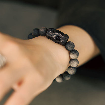 Pulsera relajante de madera de ébano y obsidiana con brillo plateado Mythstone 