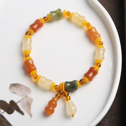 Pulsera con dije de riqueza de calabaza de jade de seda dorada natural Mythstone 