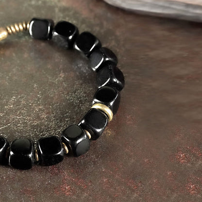 Pulsera de pareja de cobre con cristales de obsidiana negra y piedra mitológica