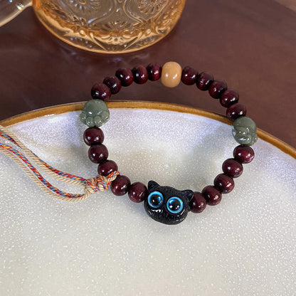 Pulsera de madera de ébano con borlas de la paz y pata de jade y gato encantador de Mythstone 