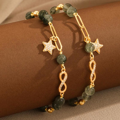 Pulsera de protección con estrellas del amor eterno y cuarzo rutilado verde en oro de 14 quilates de Mythstone con lazo Möbius 